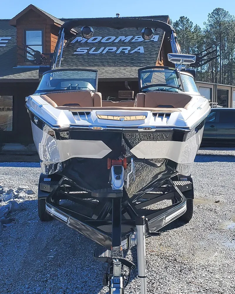 Slide: The Image of 2022 MasterCraft XStar boat on trailer in front of house. - 6