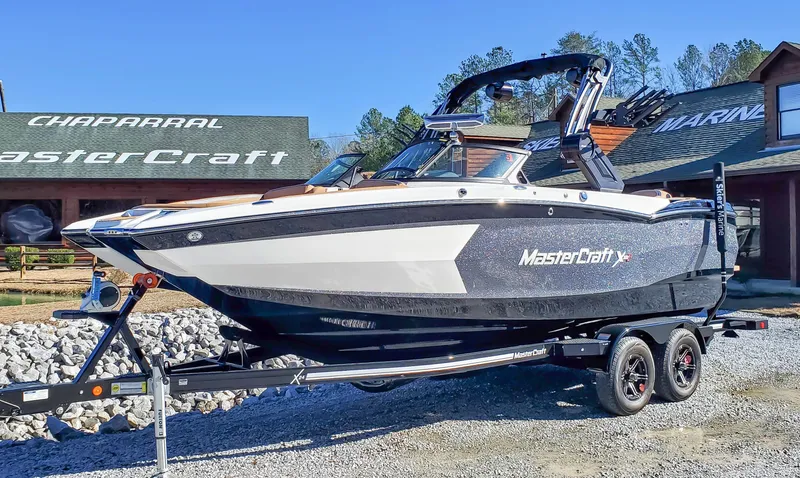 Slide: The Image of 2022 MasterCraft XStar boat on a trailer outside a dealership. - 7