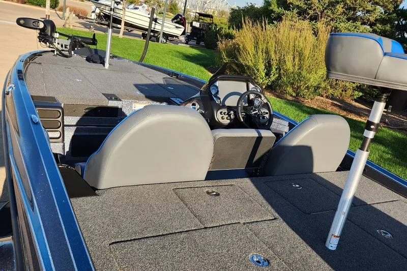 Slide: The Image of 2023 Triton 19 TrX bass boat interior with steering console and seating. - 2
