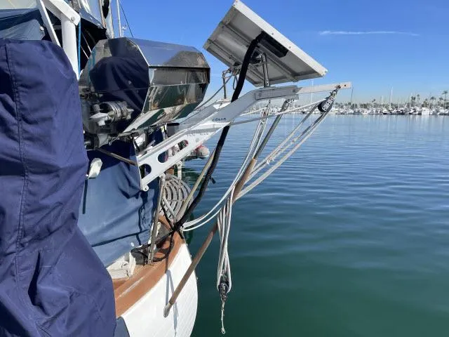 Slide: The Image of 1982 Formosa 42 sailboat with solar panels docked in a marina. - 19