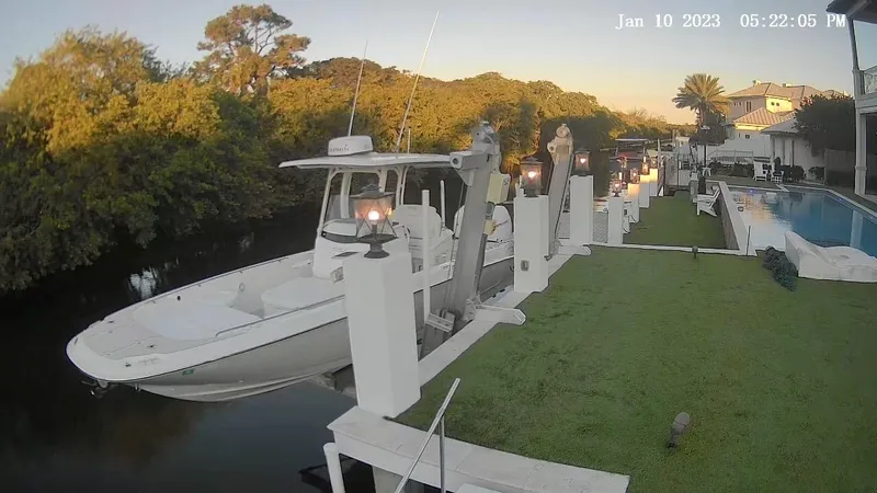 Slide: The Image of Boston Whaler Dauntless 27 boat docked by a waterfront property, January 2023. - 1