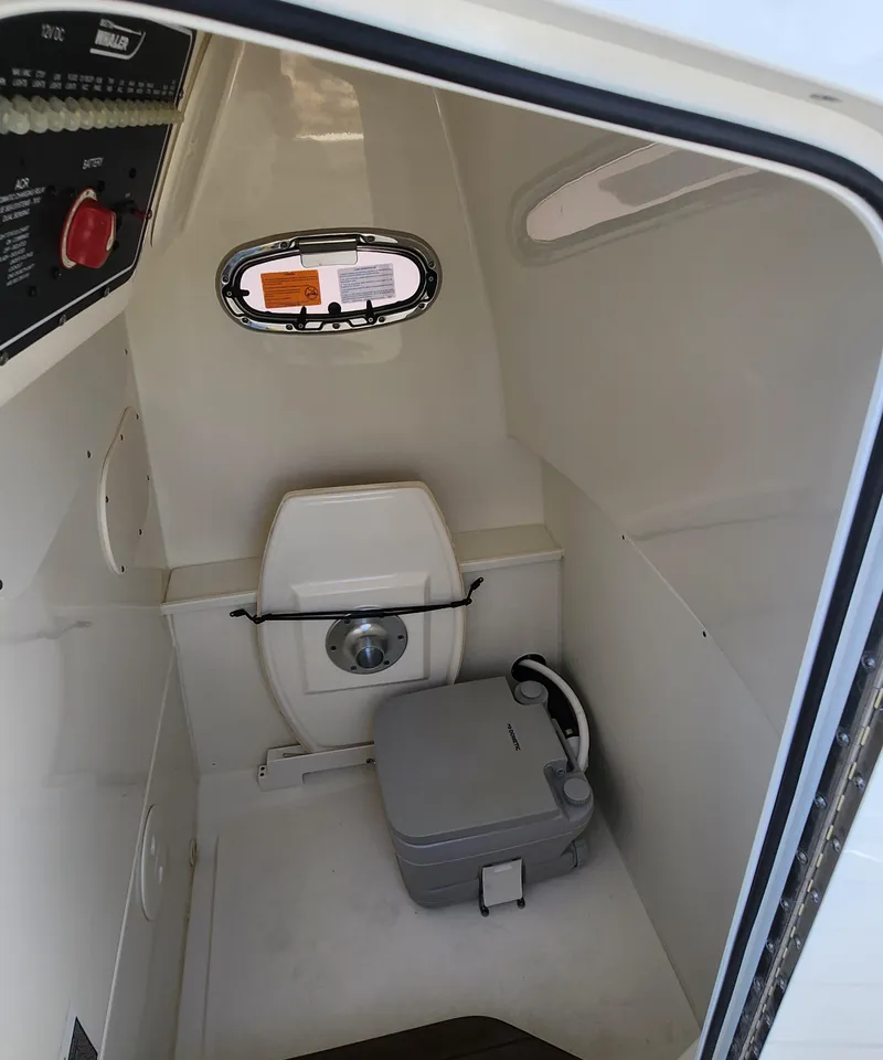 Slide: The Image of Interior of 2021 Boston Whaler Dauntless 27 boat with compact toilet. - 14