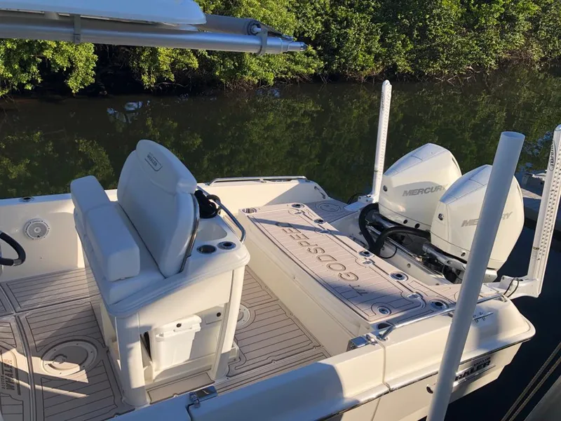 Slide: The Image of 2021 Boston Whaler Dauntless 27 boat with dual Mercury engines docked by mangroves. - 15