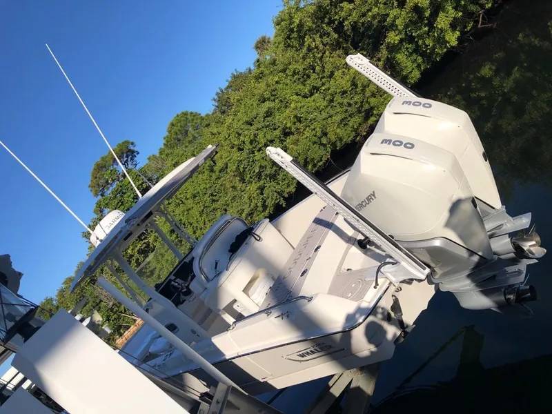 Slide: The Image of 2021 Boston Whaler Dauntless 27 boat with twin Mercury engines docked. - 18