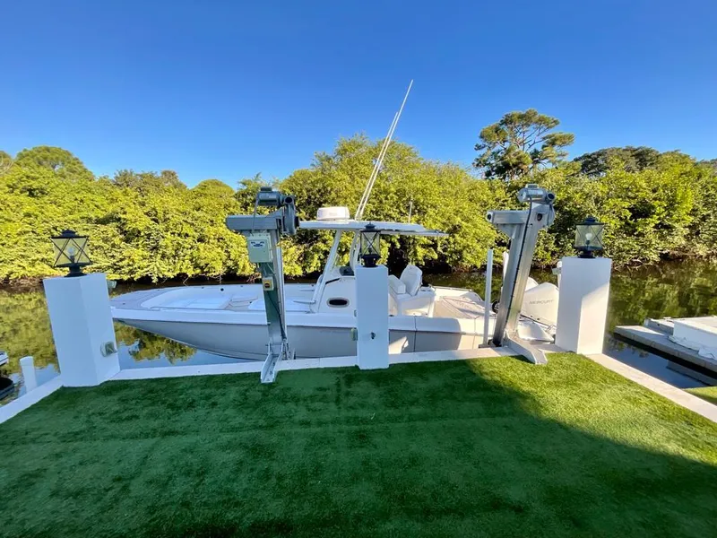 Slide: The Image of 2021 Boston Whaler Dauntless 27 docked on a sunny day. - 5