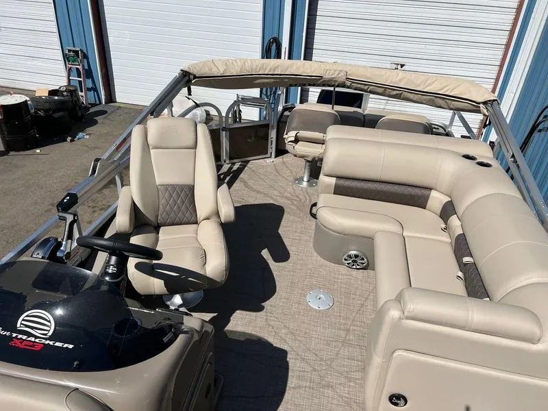 Slide: The Image of 2023 Sun Tracker SportFish™ 22 XP3 pontoon boat with beige seating and helm station. - 8