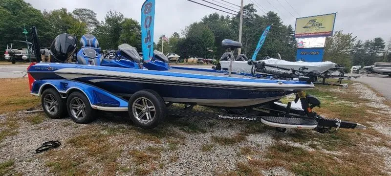 Slide: The Image of 2023 Ranger Z 521 RC boat displayed outdoors with blue accents and dual motors. - 19