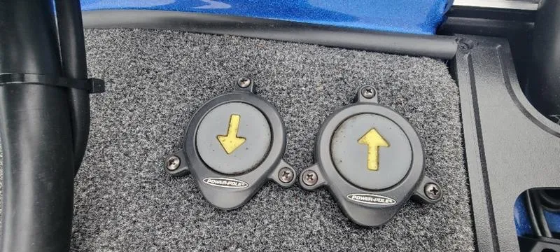 Slide: The Image of 2023 Ranger Z 521 RC boat foot pedals with directional arrows on carpeted floor. - 20