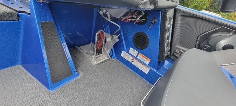 Slide: The Image of 2023 Ranger Z 521 RC boat interior with blue accents and speaker system. - 21