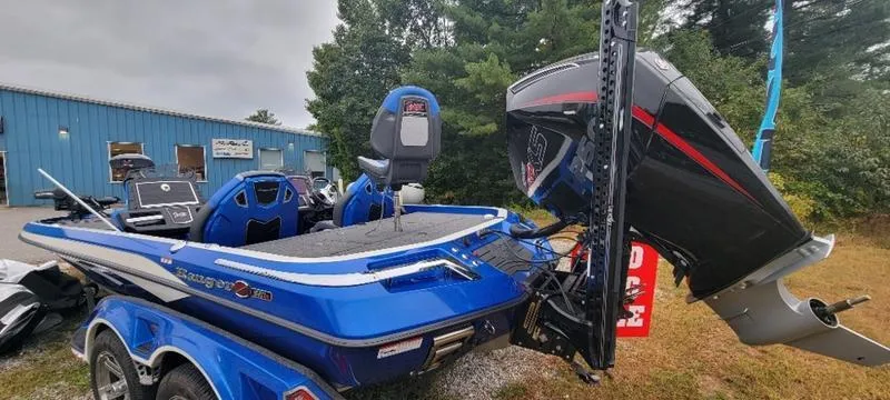 Slide: The Image of 2023 Ranger Z 521 RC boat with powerful outboard motor, parked outdoors. - 22