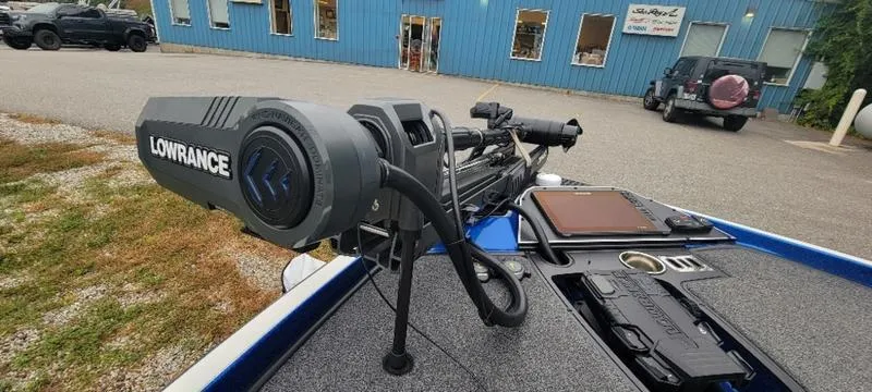 Slide: The Image of 2023 Ranger Z 521 RC boat with Lowrance equipment, parked near a blue building. - 24
