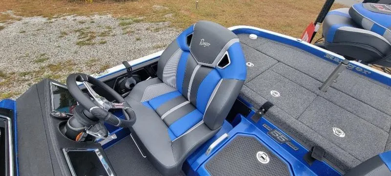 Slide: The Image of 2023 Ranger Z 521 RC boat interior with blue and gray seating. - 25