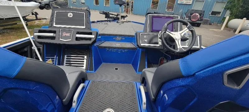 Slide: The Image of 2023 Ranger Z 521 RC boat interior with blue seats and modern dashboard. - 5