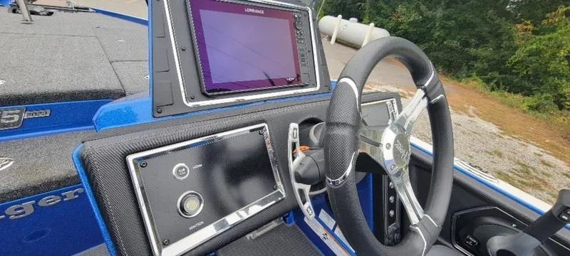 Slide: The Image of 2023 Ranger Z 521 RC boat dashboard with steering wheel and electronic display. - 6