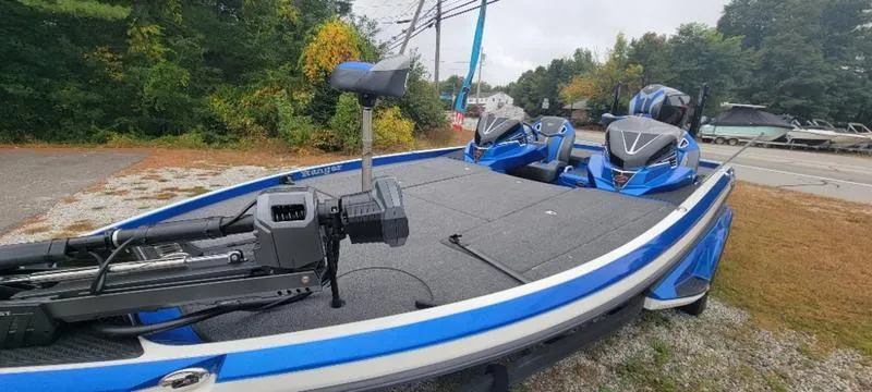 Slide: The Image of 2023 Ranger Z 521 RC fishing boat with dual motors, parked outdoors. - 7