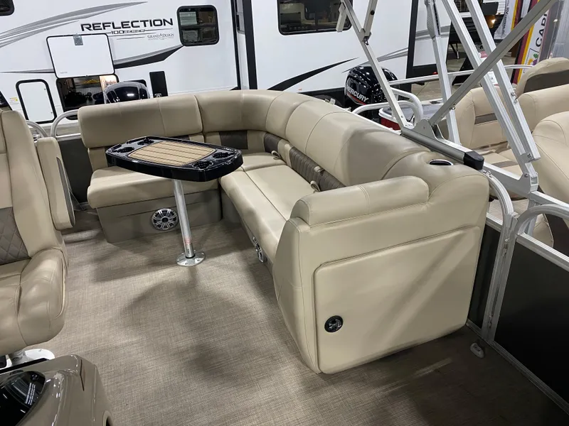 Slide: The Image of 2023 Sun Tracker Party Barge 20 DLX interior with beige seating and table. - 3