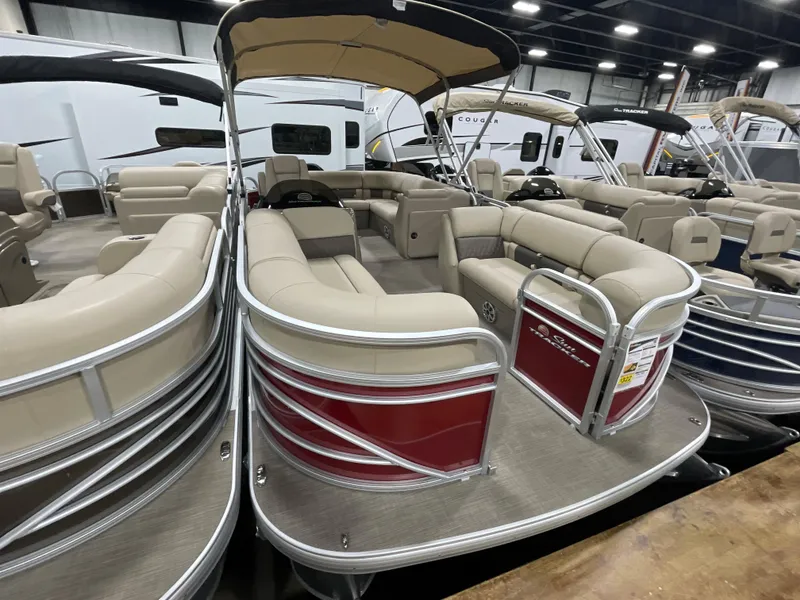 Slide: The Image of 2023 Sun Tracker Party Barge 20 DLX pontoon boat with beige seating in showroom. - 2