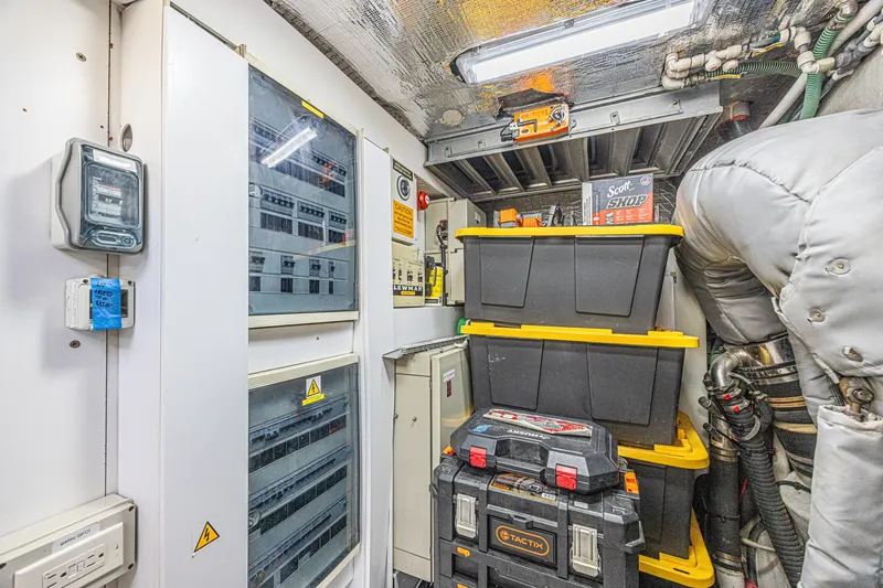 Slide: The Image of Engine room of 2013 Sunseeker Predator 84 yacht with storage boxes and control panels. - 62
