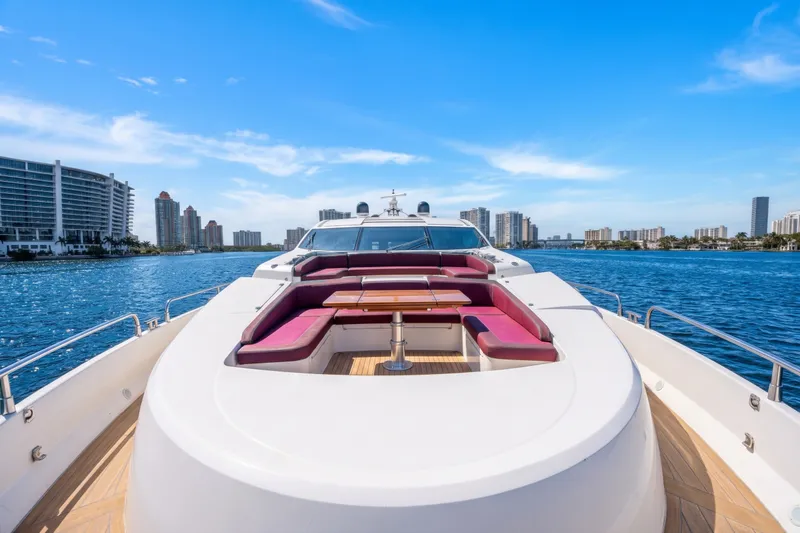 Slide: The Image of Luxurious 2013 Sunseeker Predator 84 yacht with spacious deck seating, cruising near city skyline. - 26