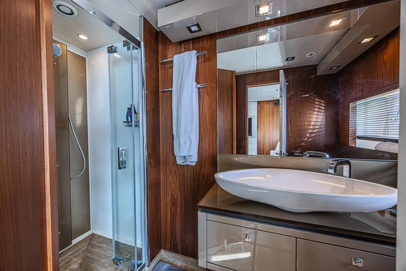 Slide: The Image of Luxurious bathroom in 2013 Sunseeker Predator 84 yacht with modern fixtures and wood accents. - 57