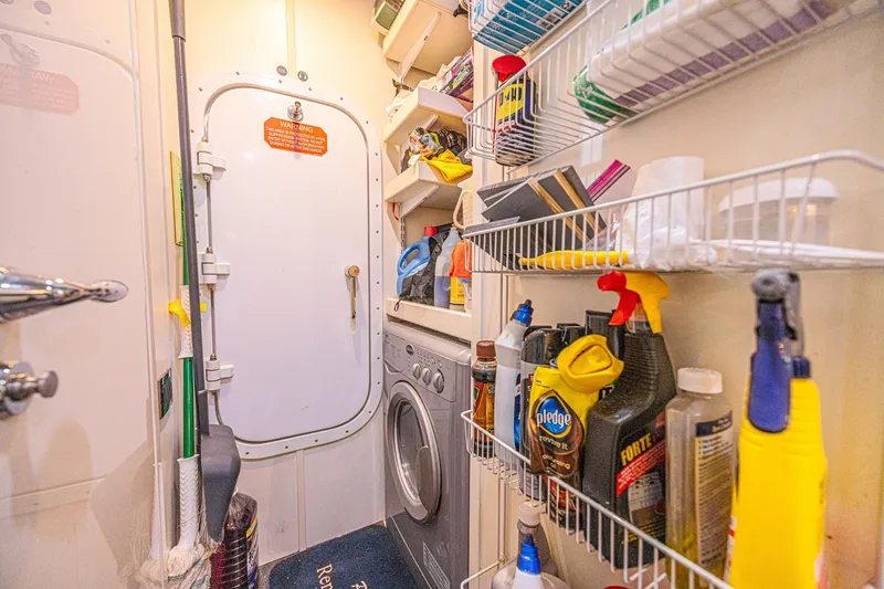 Slide: The Image of Laundry and storage area on 2013 Sunseeker Predator 84 yacht, featuring cleaning supplies and washer. - 69