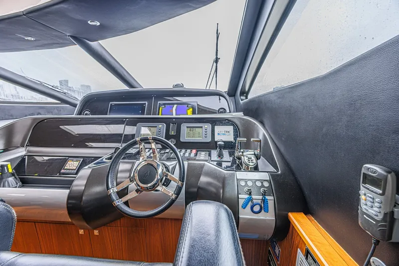 Slide: The Image of Cockpit of 2013 Sunseeker Predator 84 yacht with modern navigation equipment and steering wheel. - 40