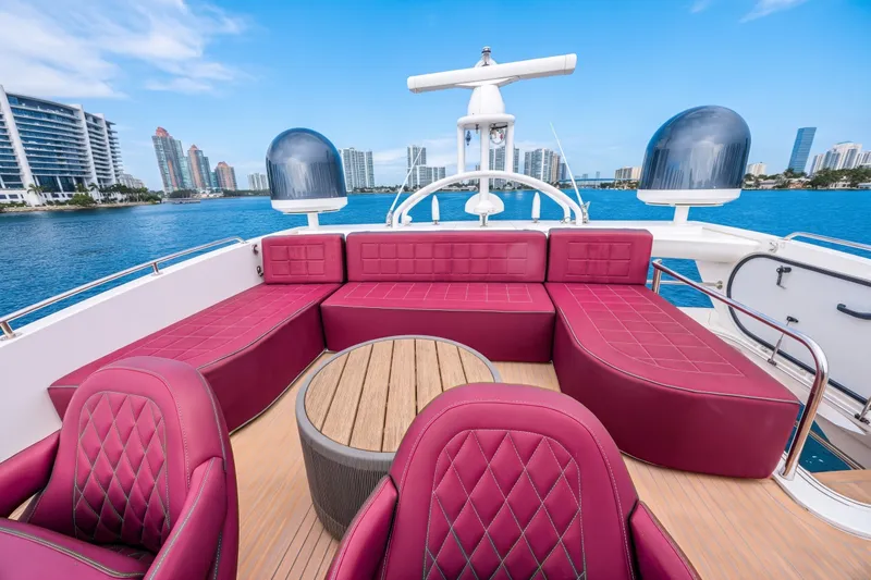 Slide: The Image of Luxurious 2013 Sunseeker Predator 84 yacht with red seating, overlooking city skyline and blue waters. - 19