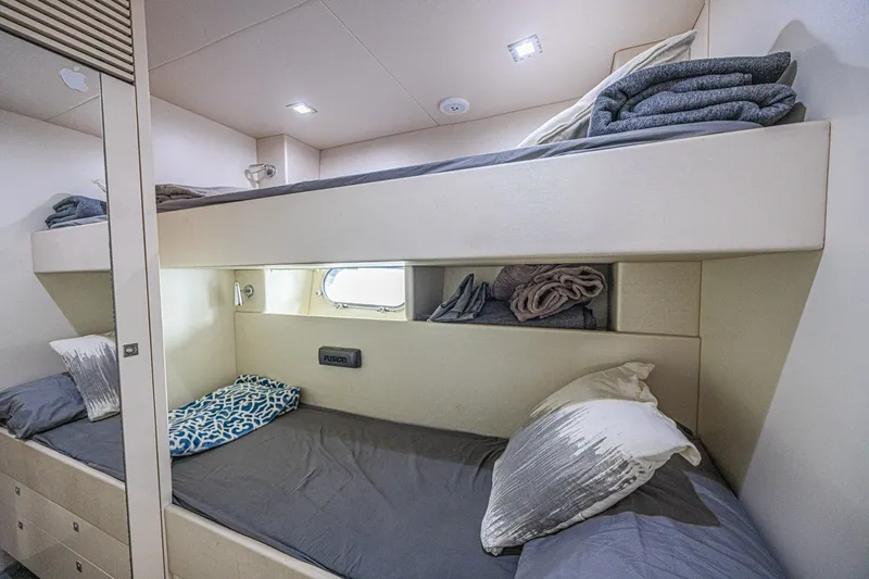 Slide: The Image of Luxurious bunk beds in 2013 Sunseeker Predator 84 yacht cabin, featuring cozy bedding and modern design. - 64