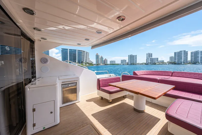 Slide: The Image of Luxurious 2013 Sunseeker Predator 84 yacht deck with seating, table, and waterfront city view. - 14
