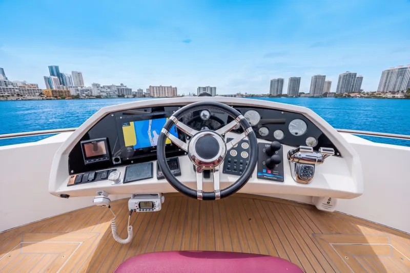 Slide: The Image of Helm of 2013 Sunseeker Predator 84 yacht with city skyline in background. - 20