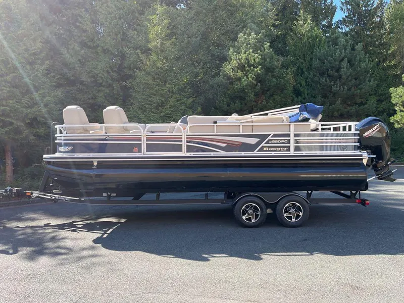 Slide: The Image of 2023 Ranger Reata 220FC pontoon boat interior with plush seating and modern helm. - 4