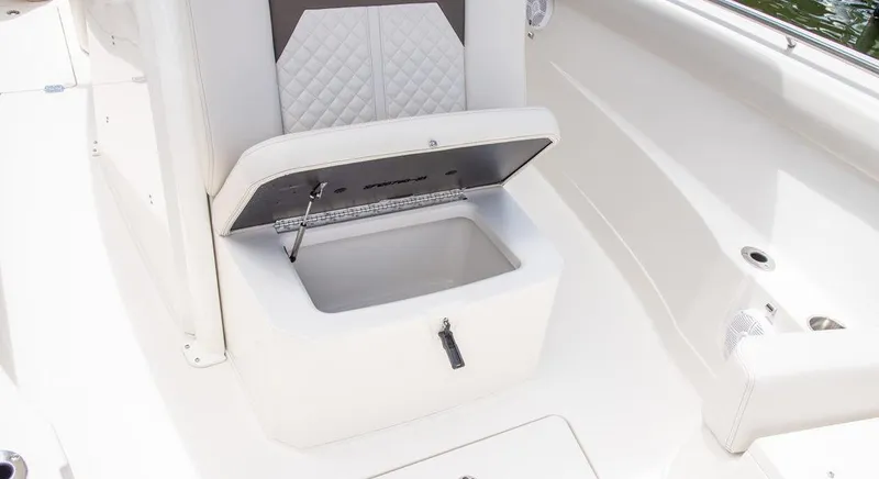 Slide: The Image of 2023 Sailfish 272 CC boat with open storage compartment under seat. - 10