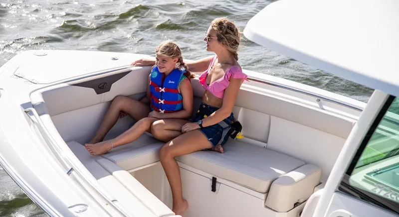 Slide: The Image of 2023 Sailfish 272 CC boat with two people relaxing on deck. - 4