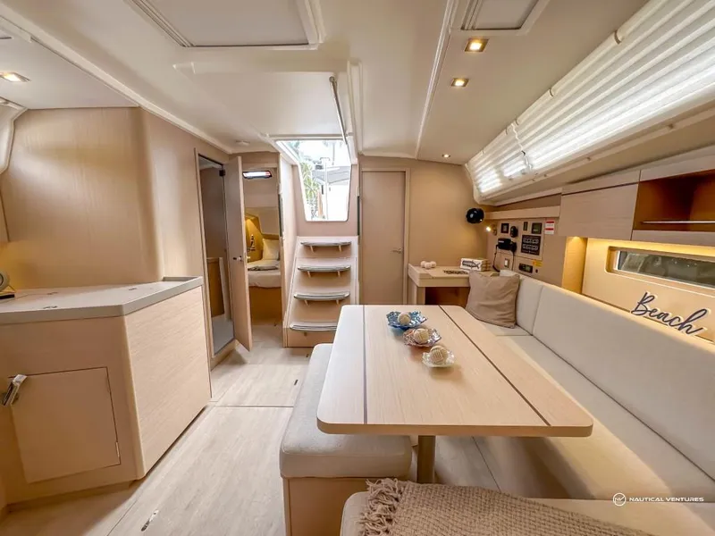 Slide: The Image of 2024 Beneteau Oceanis 40.1 interior, modern design with dining area and kitchen. - 10