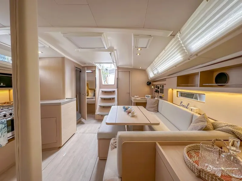 Slide: The Image of Modern interior of 2024 Beneteau Oceanis 40.1 sailboat with cozy seating and dining area. - 11