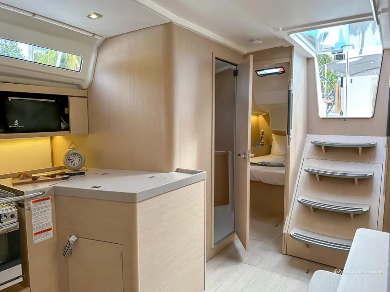 Slide: The Image of 2024 Beneteau Oceanis 40.1 interior, featuring modern kitchen, cozy bedroom, and stylish wooden finishes. - 13