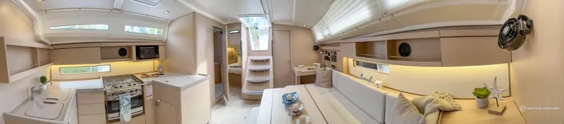 Slide: The Image of Interior of 2024 Beneteau Oceanis 40.1 sailboat with modern kitchen and seating area. - 14