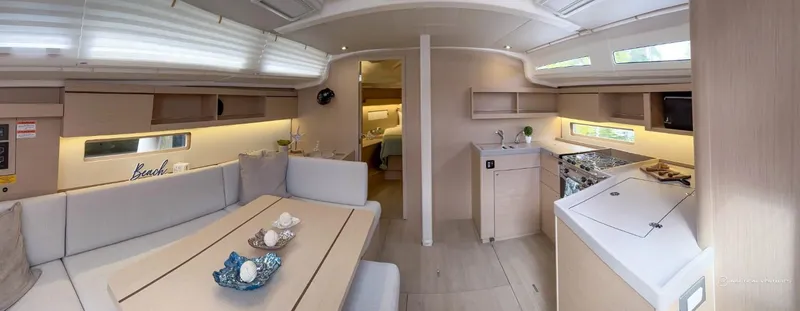 Slide: The Image of Modern interior of 2024 Beneteau Oceanis 40.1 sailboat with spacious kitchen and dining area. - 16