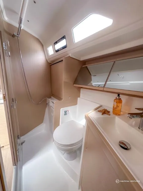Slide: The Image of 2024 Beneteau Oceanis 40.1 yacht bathroom with modern fixtures and ample lighting. - 18