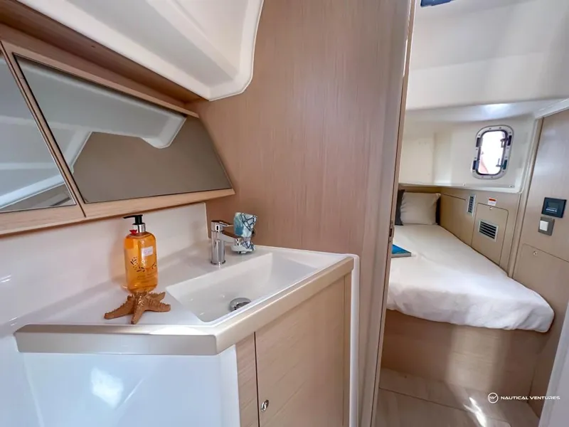 Slide: The Image of 2024 Beneteau Oceanis 40.1 interior cabin with sink and bed. - 20