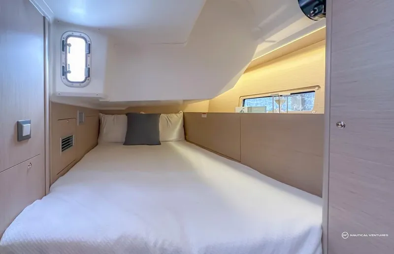 Slide: The Image of Beneteau Oceanis 40.1 2024 interior cabin with bed, window, and modern design. - 24