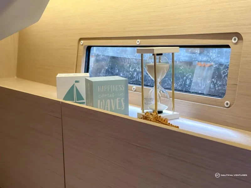 Slide: The Image of Interior of 2024 Beneteau Oceanis 40.1 with decorative items and window. - 27