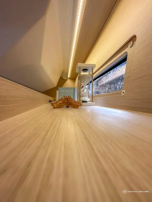 Slide: The Image of Interior detail of 2024 Beneteau Oceanis 40.1 yacht with wooden finish and decorative items. - 28