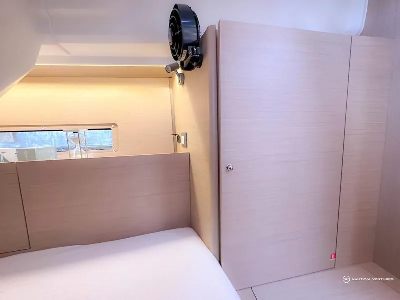 Slide: The Image of 2024 Beneteau Oceanis 40.1 cabin interior with light wood finish and window. - 29