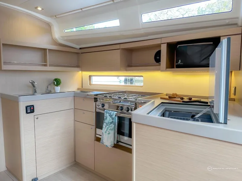 Slide: The Image of Modern kitchen in 2024 Beneteau Oceanis 40.1 yacht with stove, sink, and microwave. - 31
