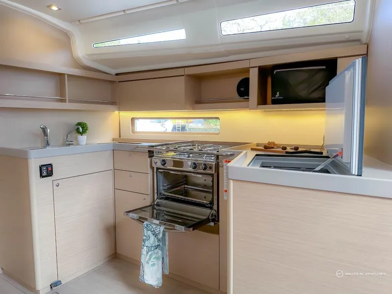 Slide: The Image of Modern kitchen in 2024 Beneteau Oceanis 40.1 sailboat with stove, sink, and ample storage. - 32