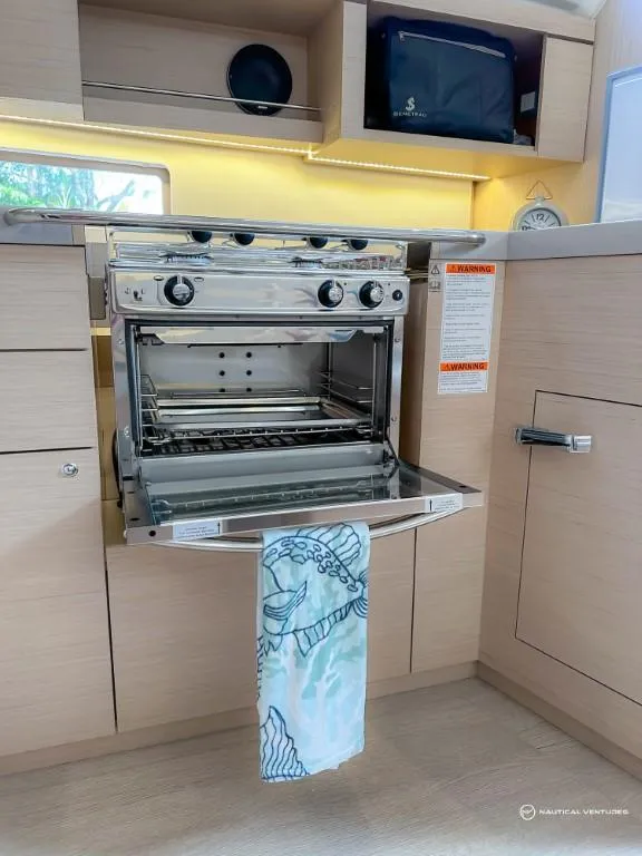 Slide: The Image of 2024 Beneteau Oceanis 40.1 yacht kitchen with open oven - 35