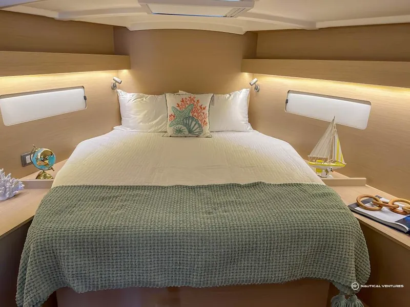 Slide: The Image of Luxurious bedroom in 2024 Beneteau Oceanis 40.1 yacht with cozy bedding and nautical decor. - 4