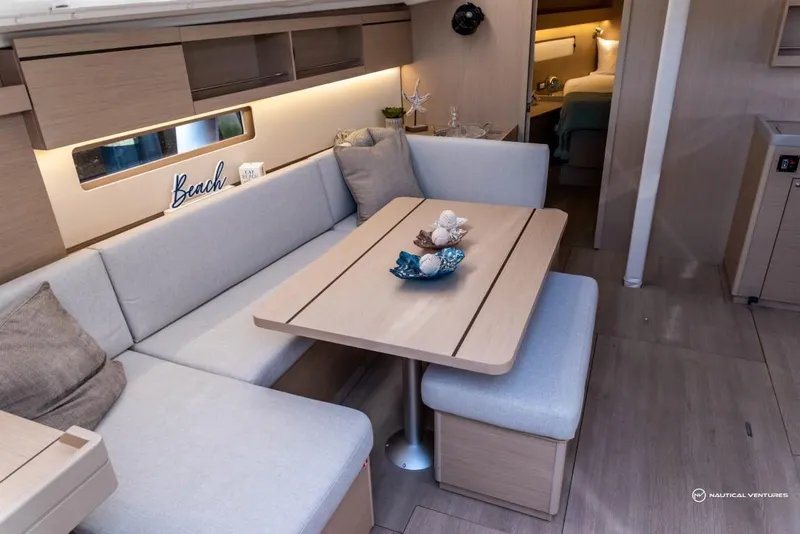 Slide: The Image of 2024 Beneteau Oceanis 40.1 interior with cozy seating and dining area. - 43