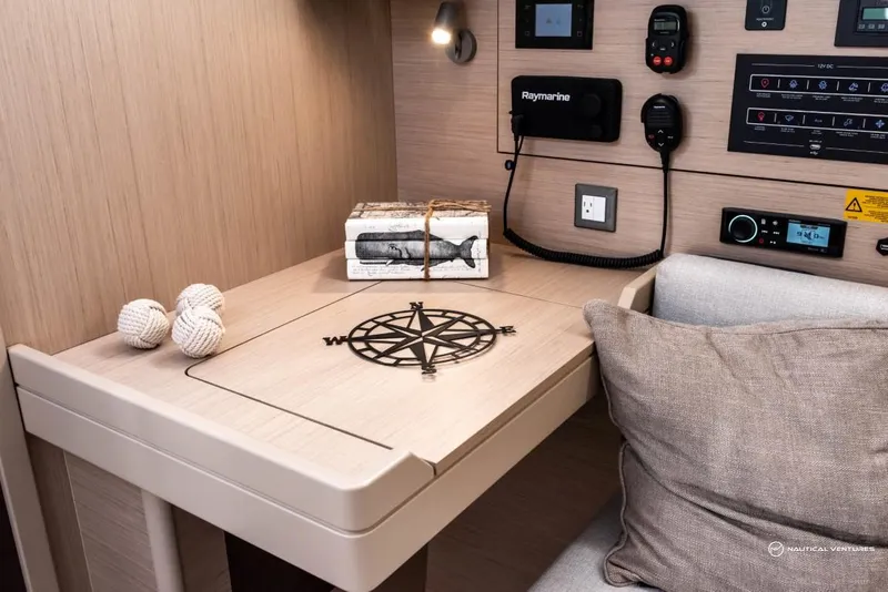 Slide: The Image of Beneteau Oceanis 40.1 2024 interior navigation station with compass design and nautical decor. - 45